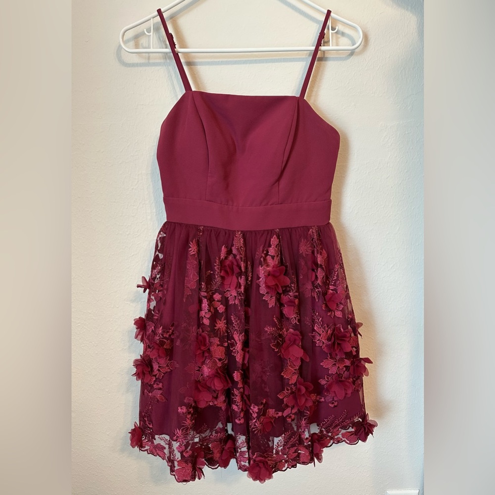 Trixxi formal wine colored mini dress with floral pattern.